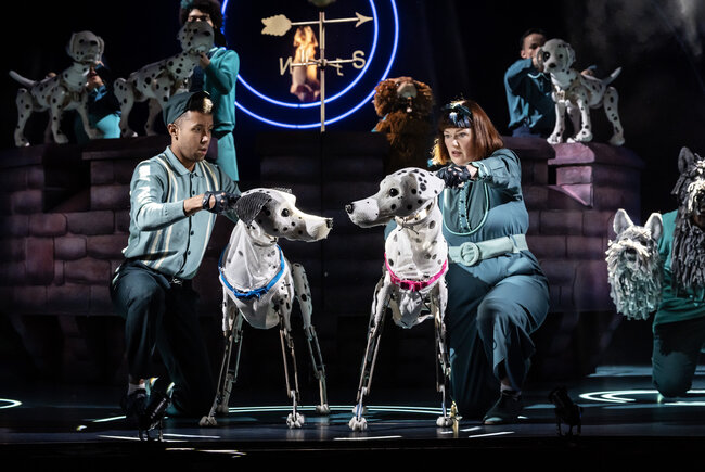 Puppet Dalmatians being operated by handlers.